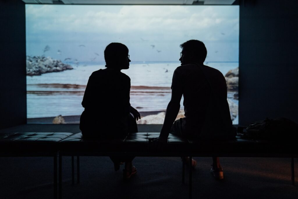 Silhouette of two people having a conversation